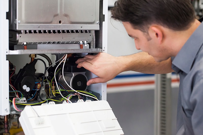 Technician diagnosing a heat pump.