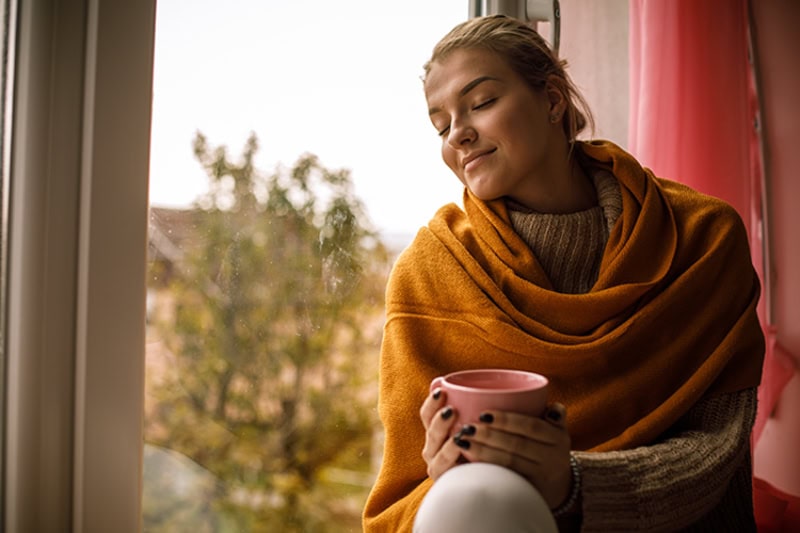 Female homeowner enjoying the indoor air quality in her Utah home during the fall.